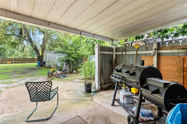 a view of a house with a big yard and large trees