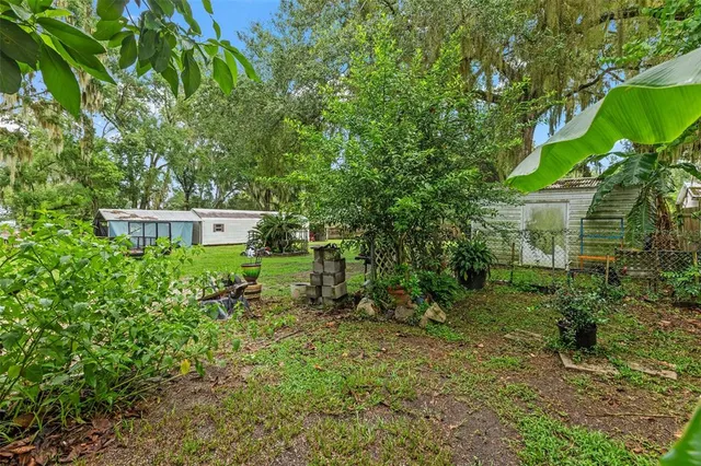 a view of an house with backyard space and balcony