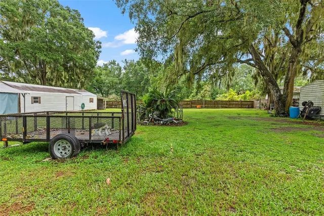 an aerial view of a house with a garden and trees