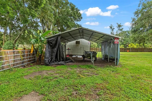 an aerial view of a house with swimming pool and garden