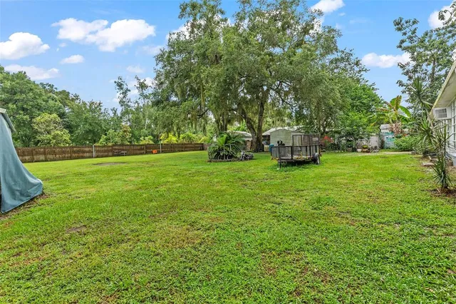 an aerial view of a house with a yard and garden