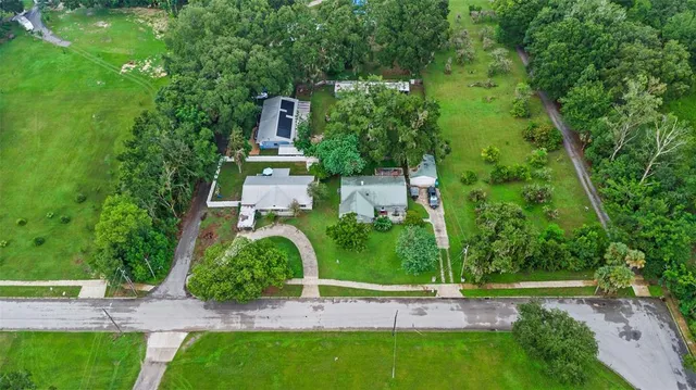 a backyard of a house with a yard and outdoor seating