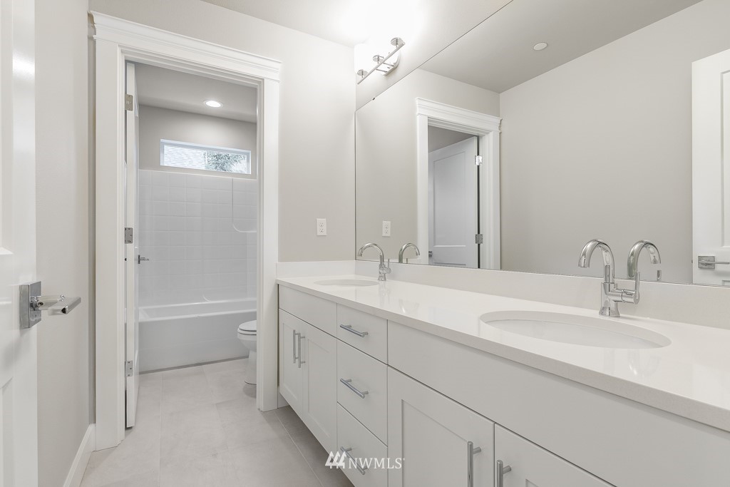 22925 31st Avenue Southeast Bothell, WA 98021 - Photo 5 of 11 a bathroom with a double vanity sink mirror and a bathtub