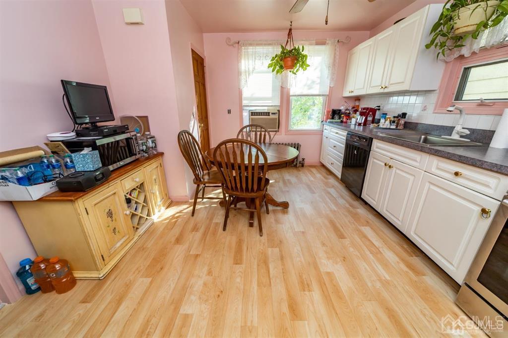 28 Niles Street Elizabeth, NJ 07202 - Photo 11 of 35 a kitchen with wooden floors and a sink