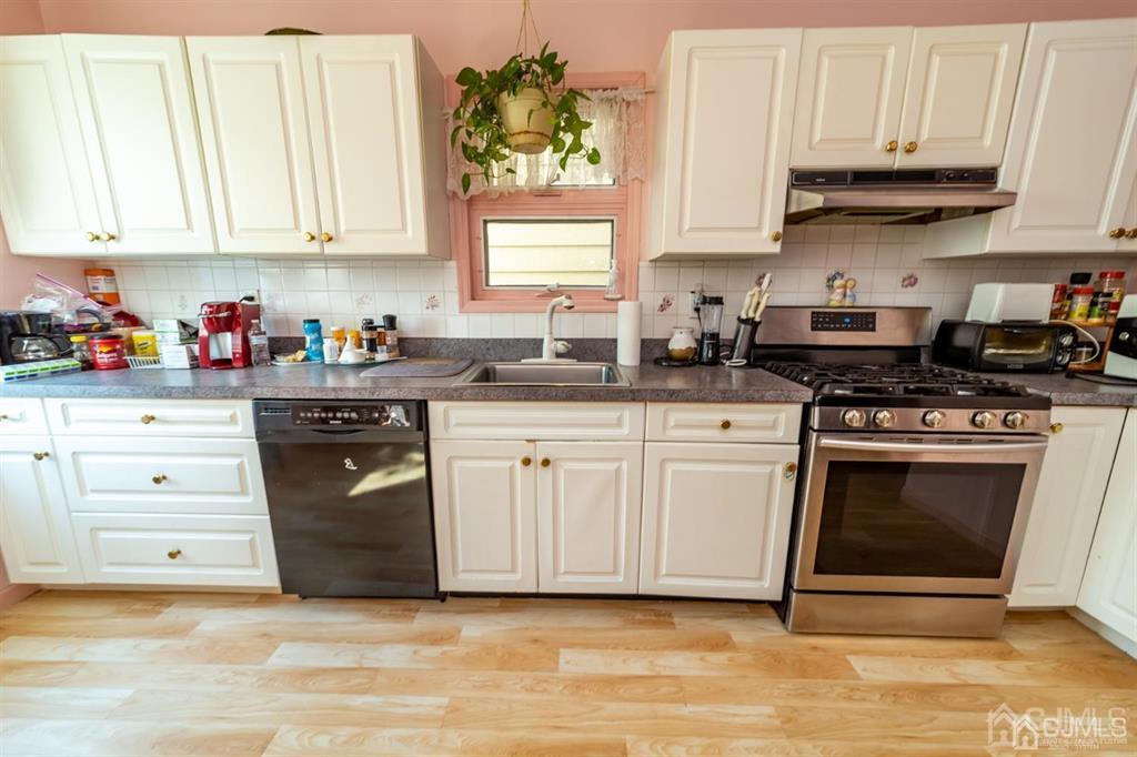 28 Niles Street Elizabeth, NJ 07202 - Photo 13 of 35 a kitchen with white cabinets and appliances