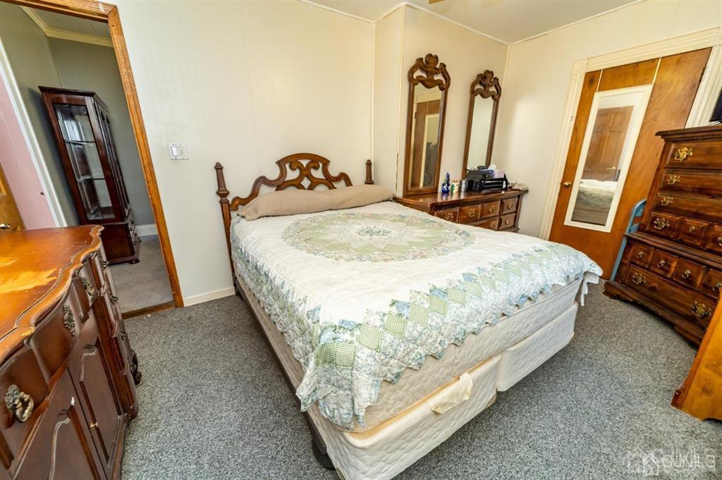 28 Niles Street Elizabeth, NJ 07202 - Photo 15 of 35 a bed sitting in a bedroom next to a window
