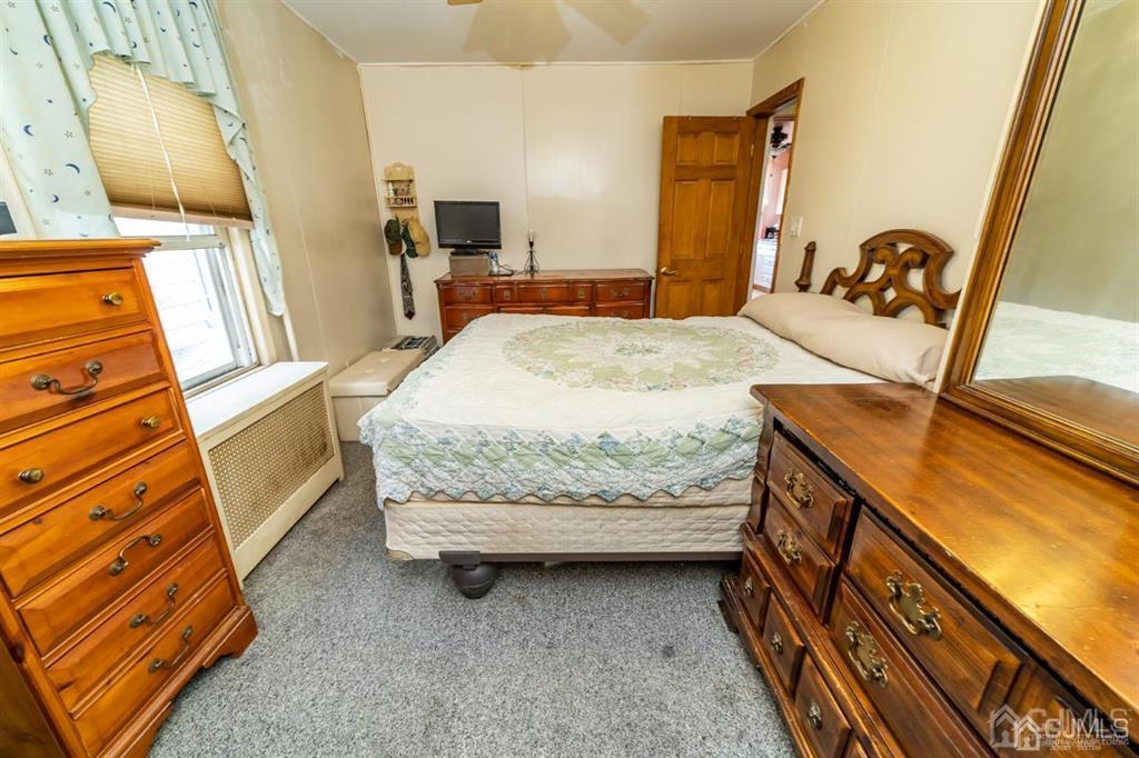 28 Niles Street Elizabeth, NJ 07202 - Photo 16 of 35 a bedroom with a bed and wooden floor