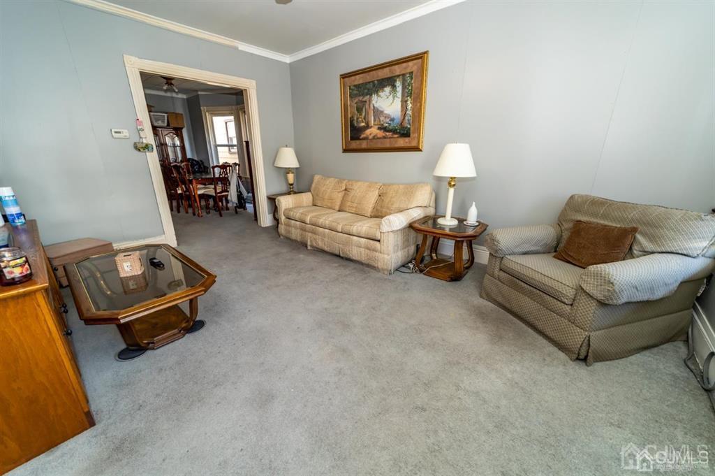28 Niles Street Elizabeth, NJ 07202 - Photo 4 of 35 a living room with furniture and a table