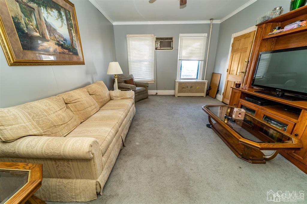 28 Niles Street Elizabeth, NJ 07202 - Photo 6 of 35 a living room with a couch and a flat screen tv