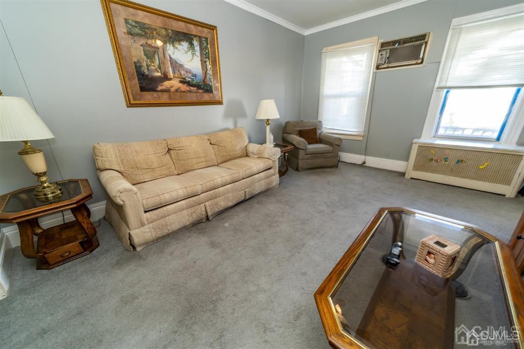 28 Niles Street Elizabeth, NJ 07202 - Photo 7 of 35 a living room with furniture and a mirror