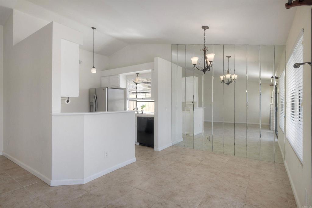 1394 Longfellow Road Vista, CA 92081 - Photo 17 of 50 an empty room with kitchen view and wooden floor