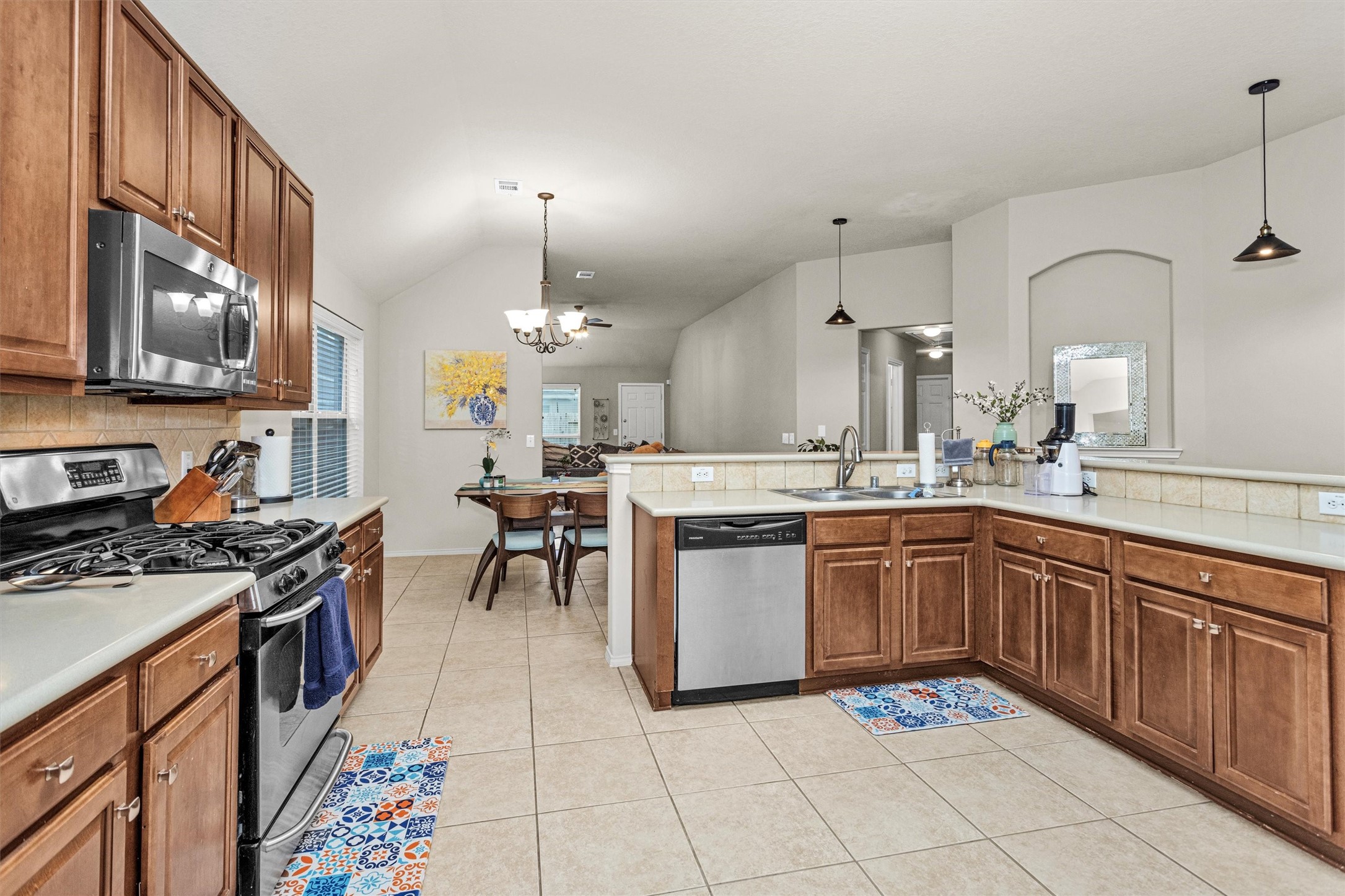 30406 Mesa Valley Drive Spring, TX 77386 - Photo 13 of 29 a kitchen with stainless steel appliances granite countertop a stove a sink and a refrigerator