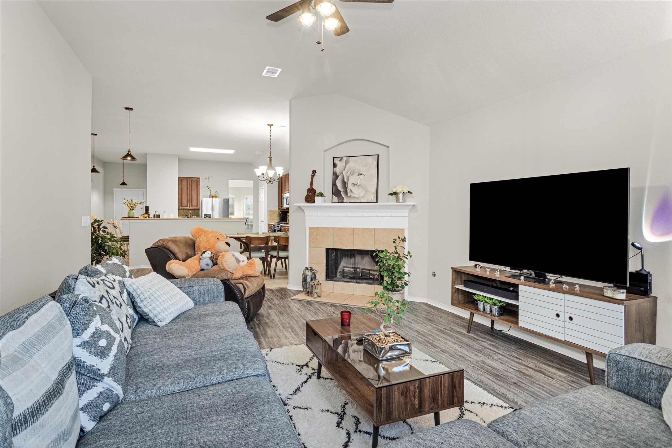 30406 Mesa Valley Drive Spring, TX 77386 - Photo 17 of 29 a living room with furniture a fireplace and a flat screen tv