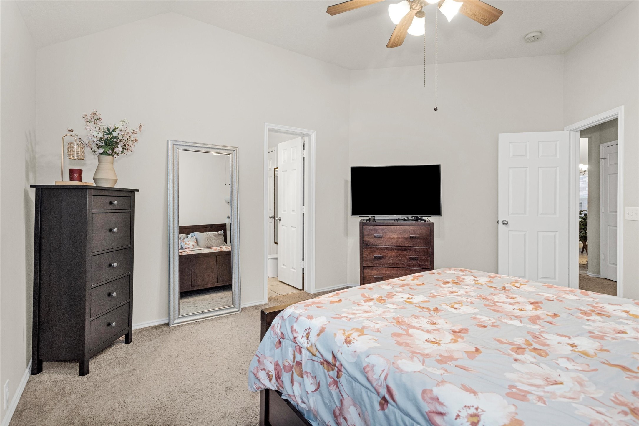 30406 Mesa Valley Drive Spring, TX 77386 - Photo 20 of 29 a large bedroom with a bed and a flat tv screen on dresser