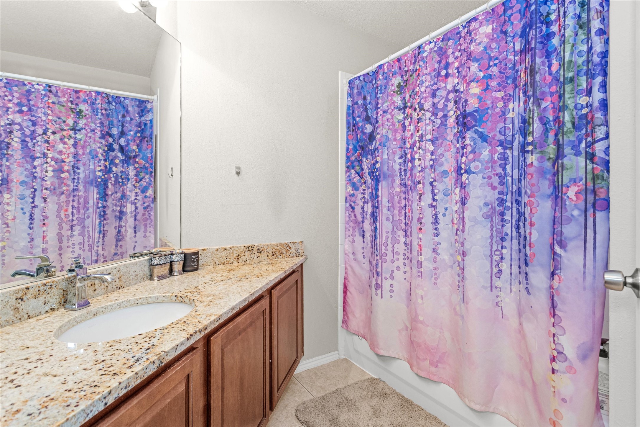 30406 Mesa Valley Drive Spring, TX 77386 - Photo 24 of 29 a bathroom with a granite countertop sink and a mirror