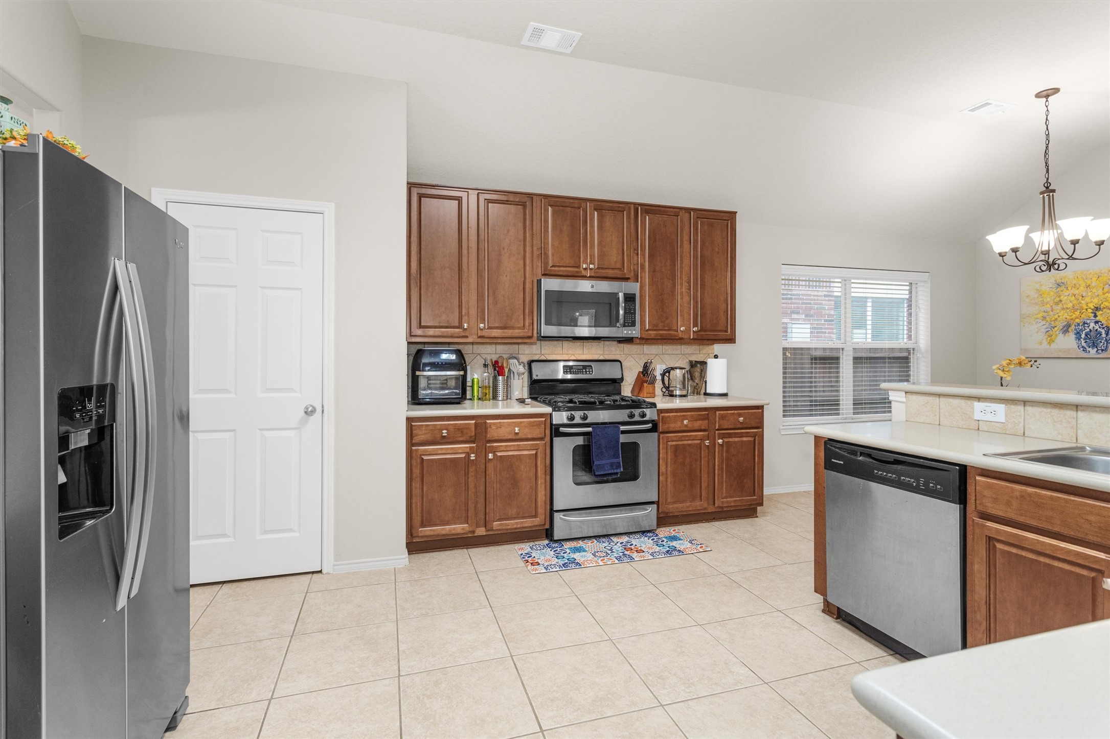 30406 Mesa Valley Drive Spring, TX 77386 - Photo 3 of 29 a kitchen with stainless steel appliances granite countertop a refrigerator stove and sink