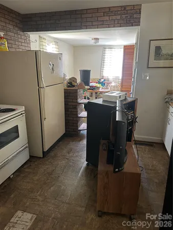 a room with furniture a window and a refrigerator
