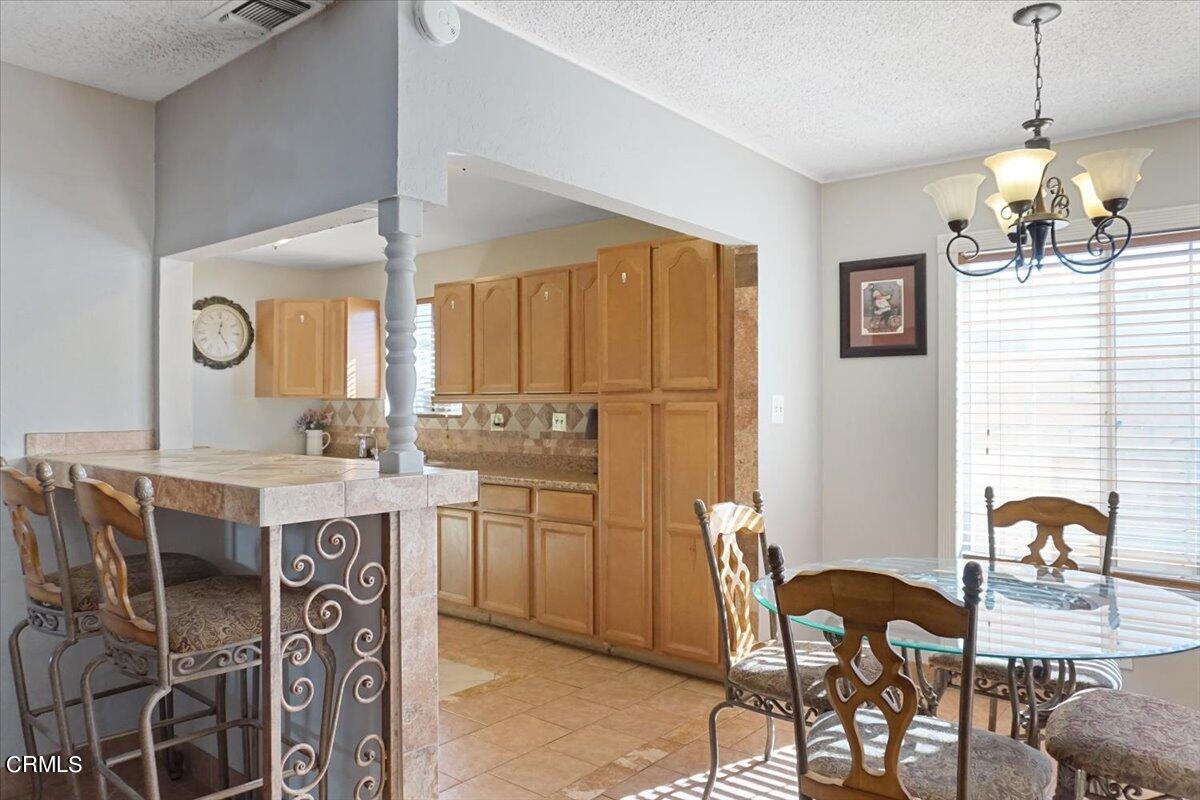 313 Rhodes Court Fillmore, CA 93015 - Photo 2 of 10 a kitchen with a table chairs stove and cabinets