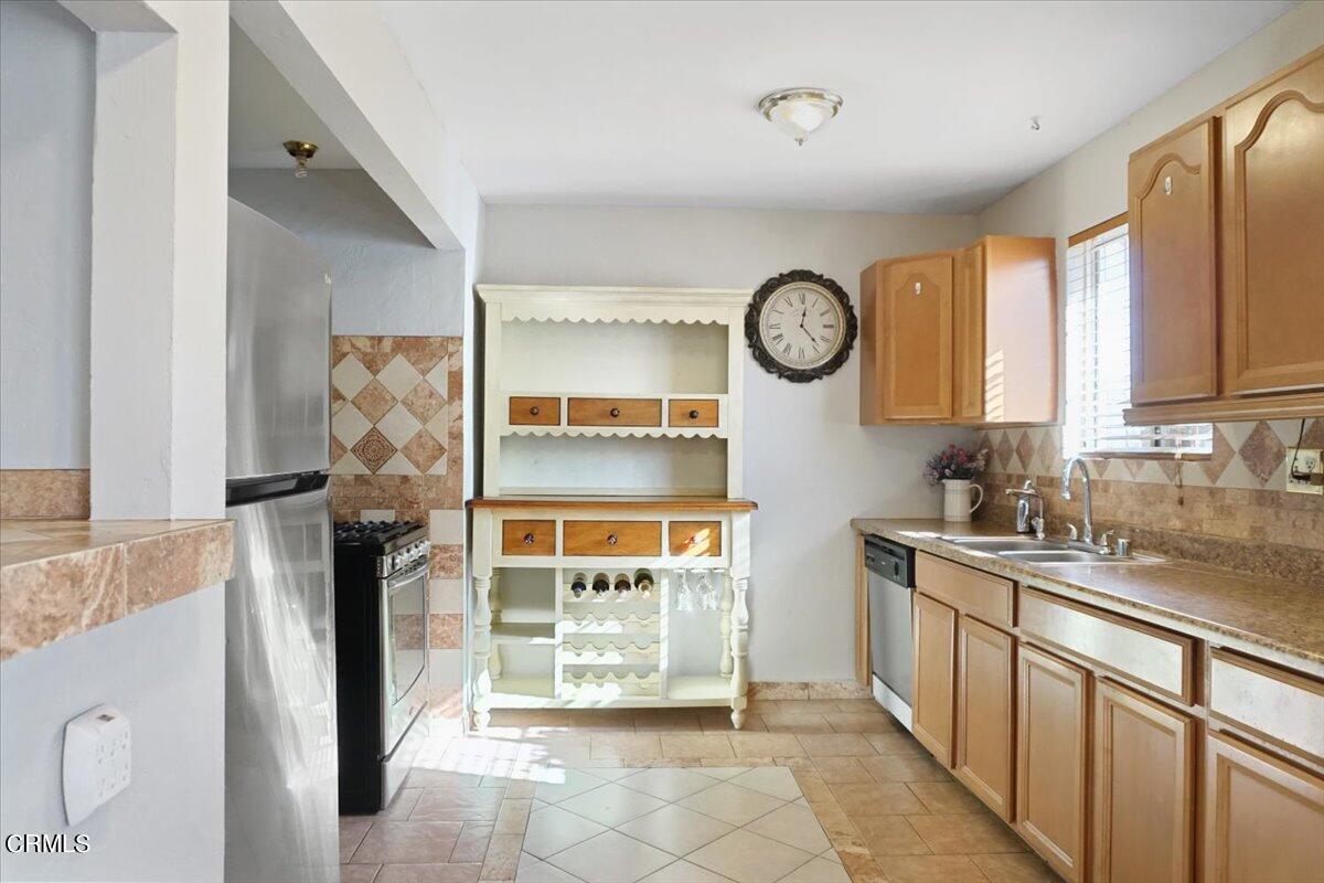 313 Rhodes Court Fillmore, CA 93015 - Photo 3 of 10 a view of kitchen with stainless steel appliances granite countertop a stove and a sink