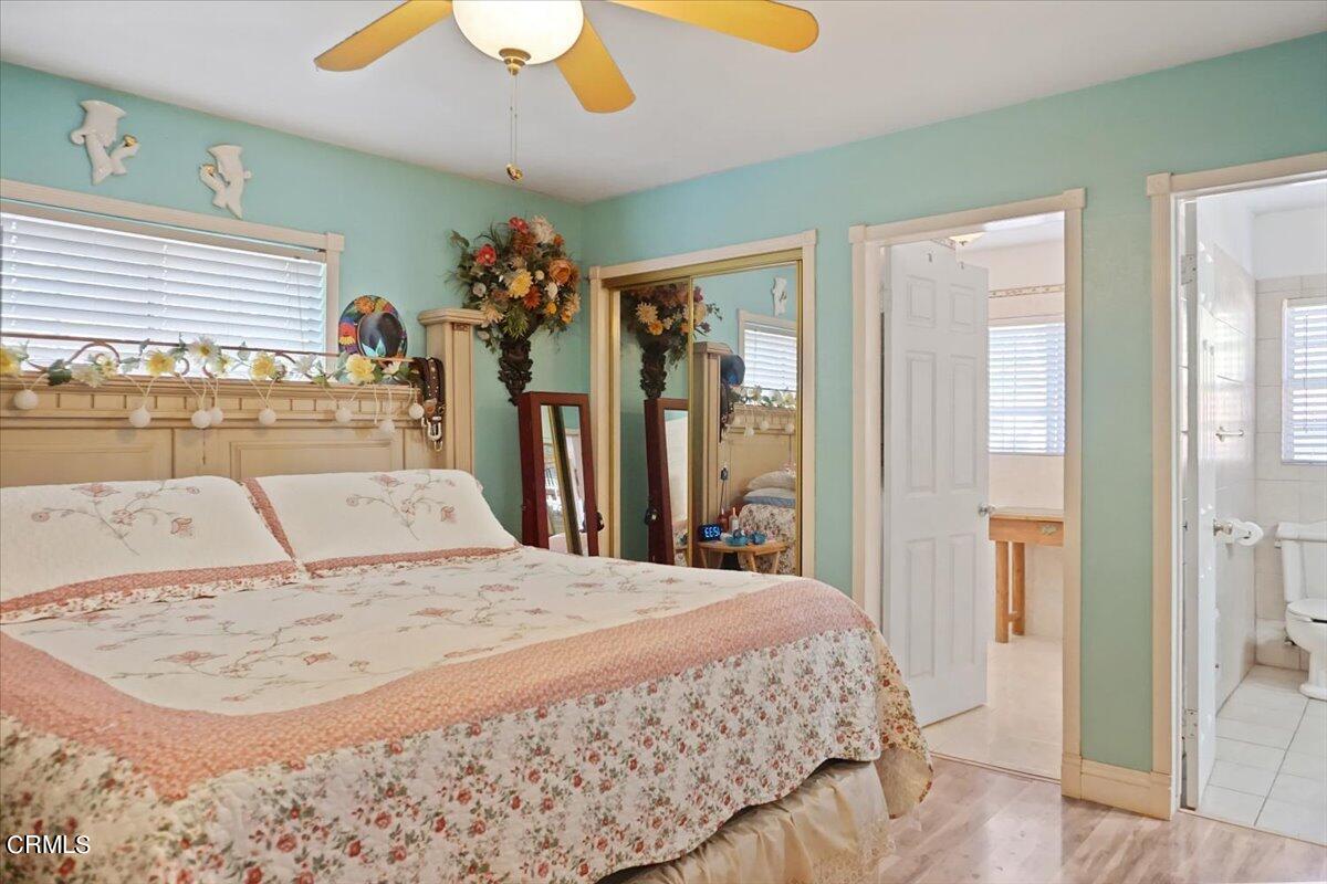 313 Rhodes Court Fillmore, CA 93015 - Photo 6 of 10 a large bedroom with a large bed and a chandelier