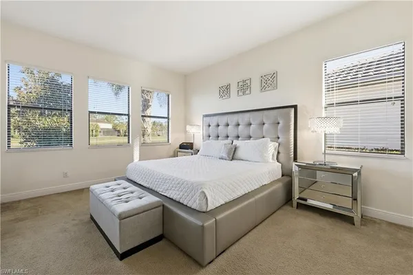 a bed sitting in a bedroom next to a window