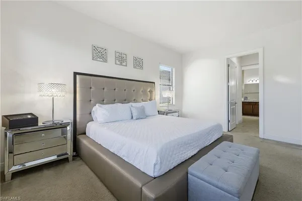 a bedroom with a bed and a night stand