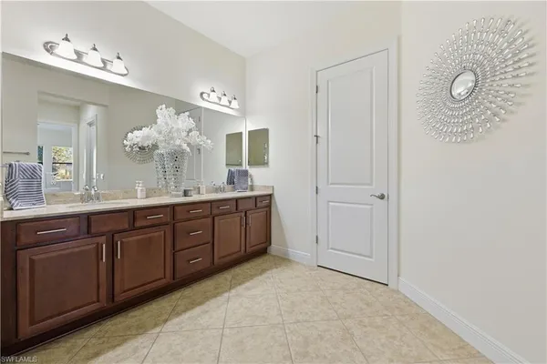 a spacious bathroom with a double vanity sink and a mirror