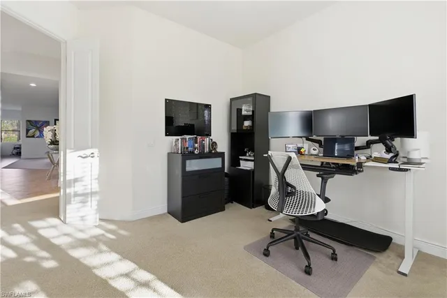 a view of a workspace with furniture and a flat screen tv