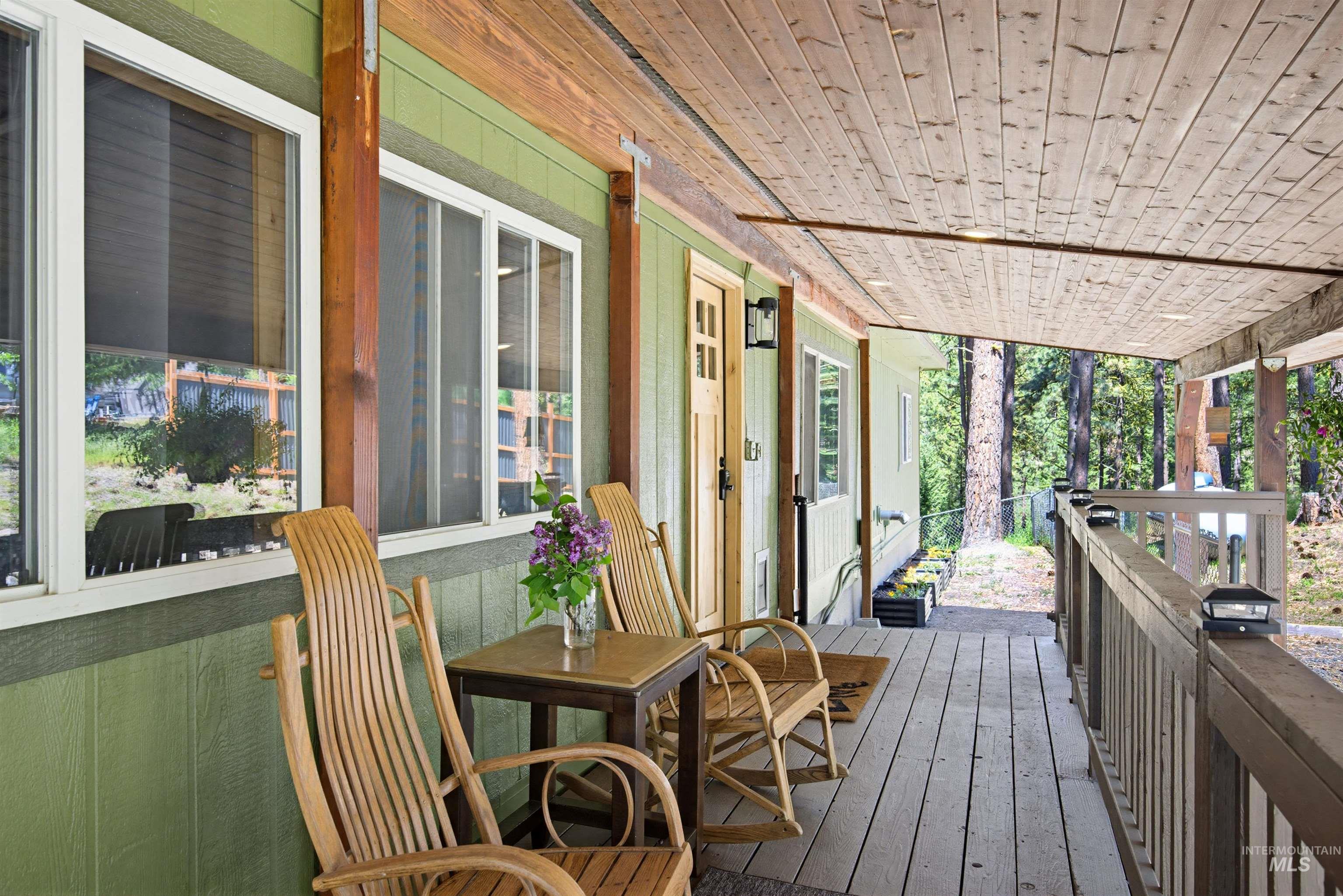 79 Sunset Loop Cascade, ID 83611 - Photo 37 of 44 Covered wood-plank porch with a natural wood ceiling, wood siding, and white-framed windows
