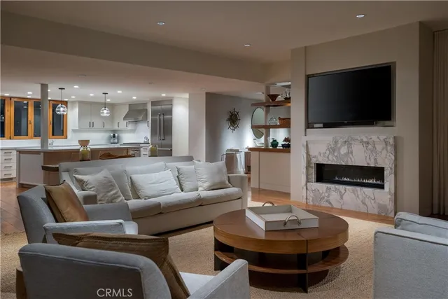 a living room with fireplace furniture and a flat screen tv