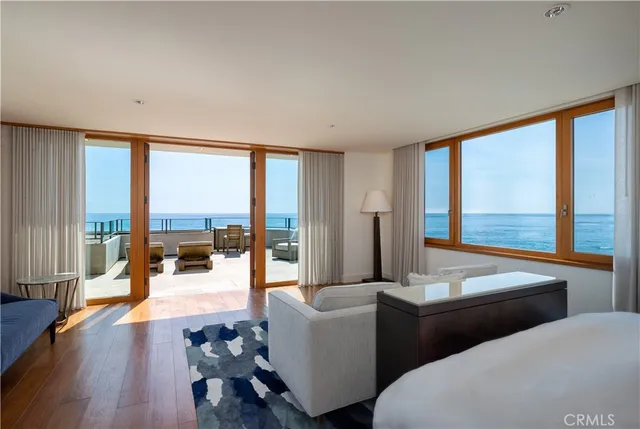 a living room with couches and a large window with balcony view