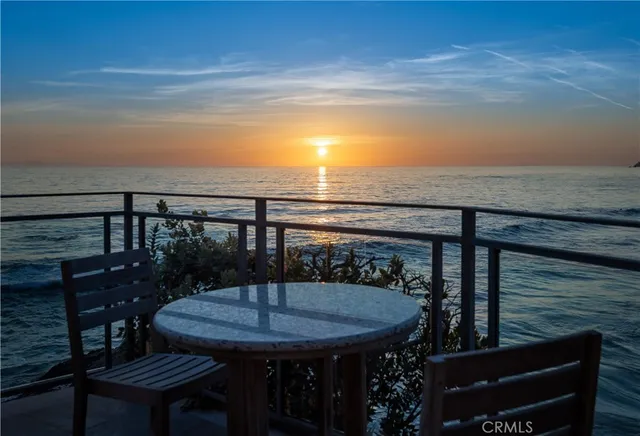 a view of a balcony with a table and chairs