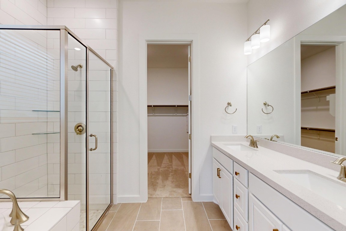 3944 Fulton Drive Leander, TX 78641 - Photo 13 of 23 a bathroom with a double vanity sink and mirror