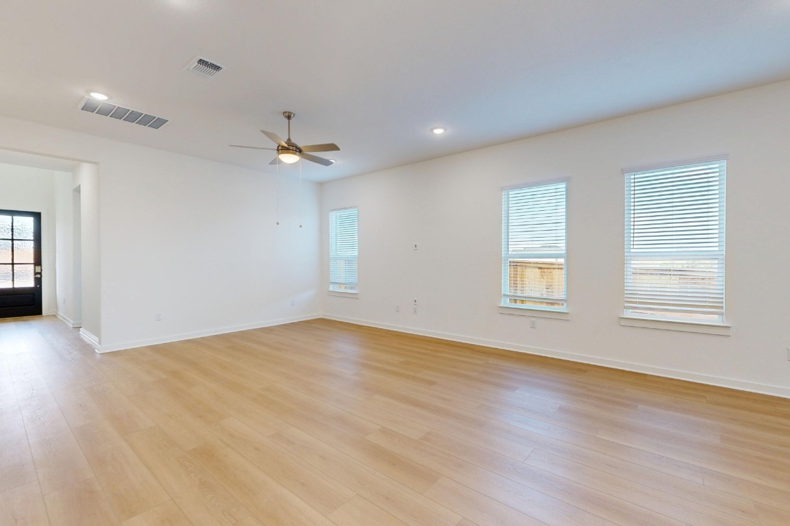 3944 Fulton Drive Leander, TX 78641 - Photo 2 of 23 a view of an empty room with a window and wooden floor