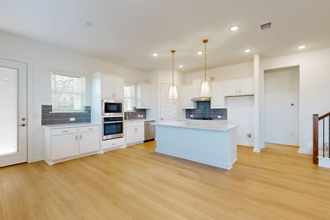 3944 Fulton Drive Leander, TX 78641 - Photo 5 of 23 a large kitchen with cabinets and a window