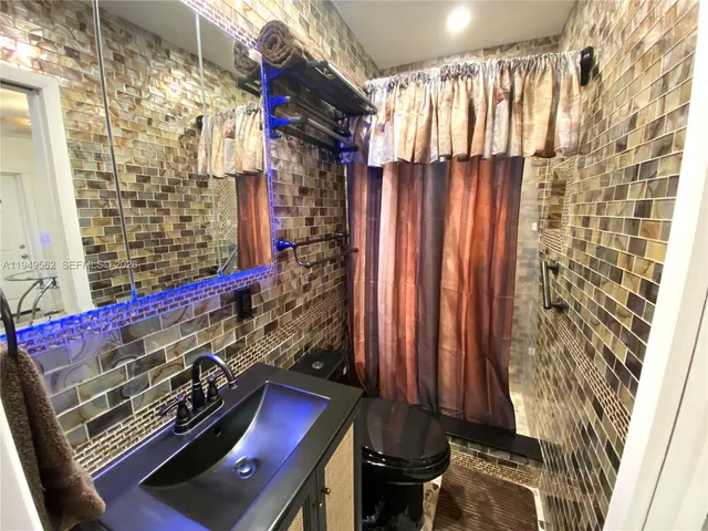 a view of a room with windows and furniture