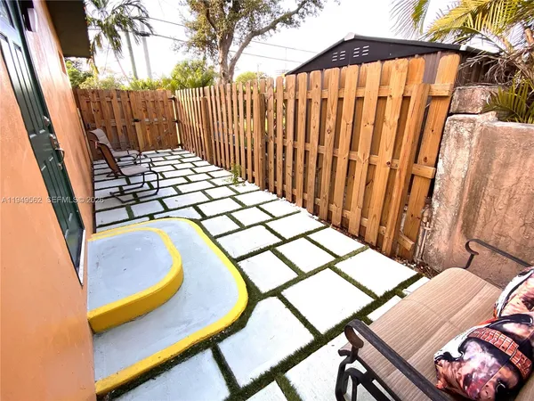 a view of a chairs and table in backyard