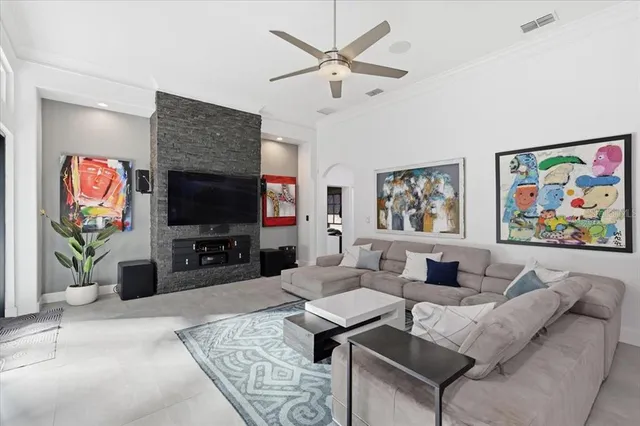 a living room with furniture a flat screen tv and a fireplace