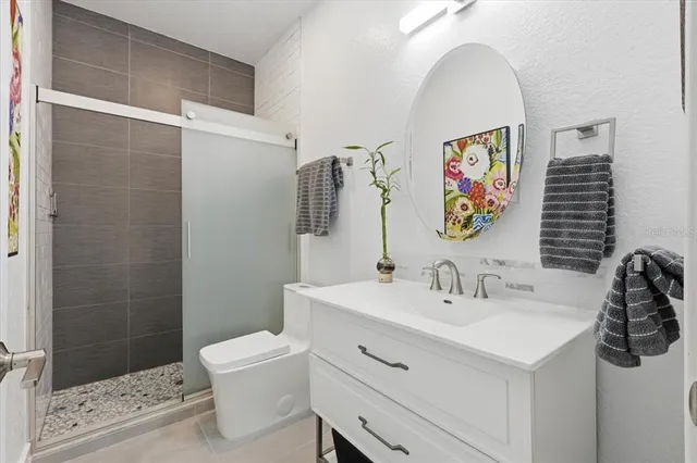 a bathroom with a sink toilet and shower