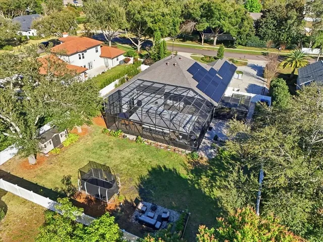 an aerial view of a house with a yard basket ball court and outdoor seating