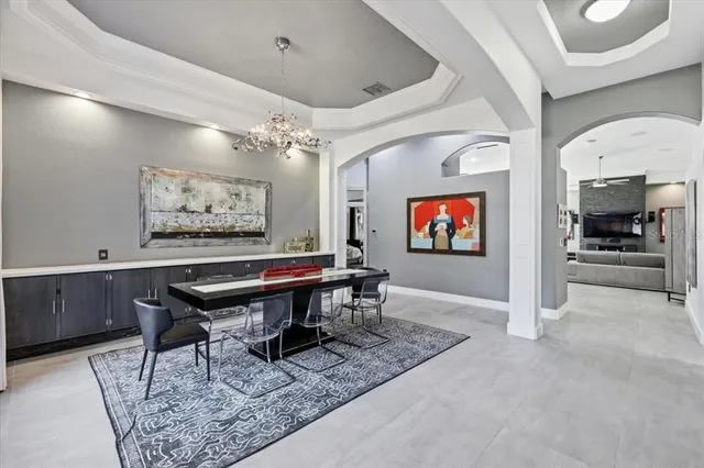 a room with furniture a projector and screen