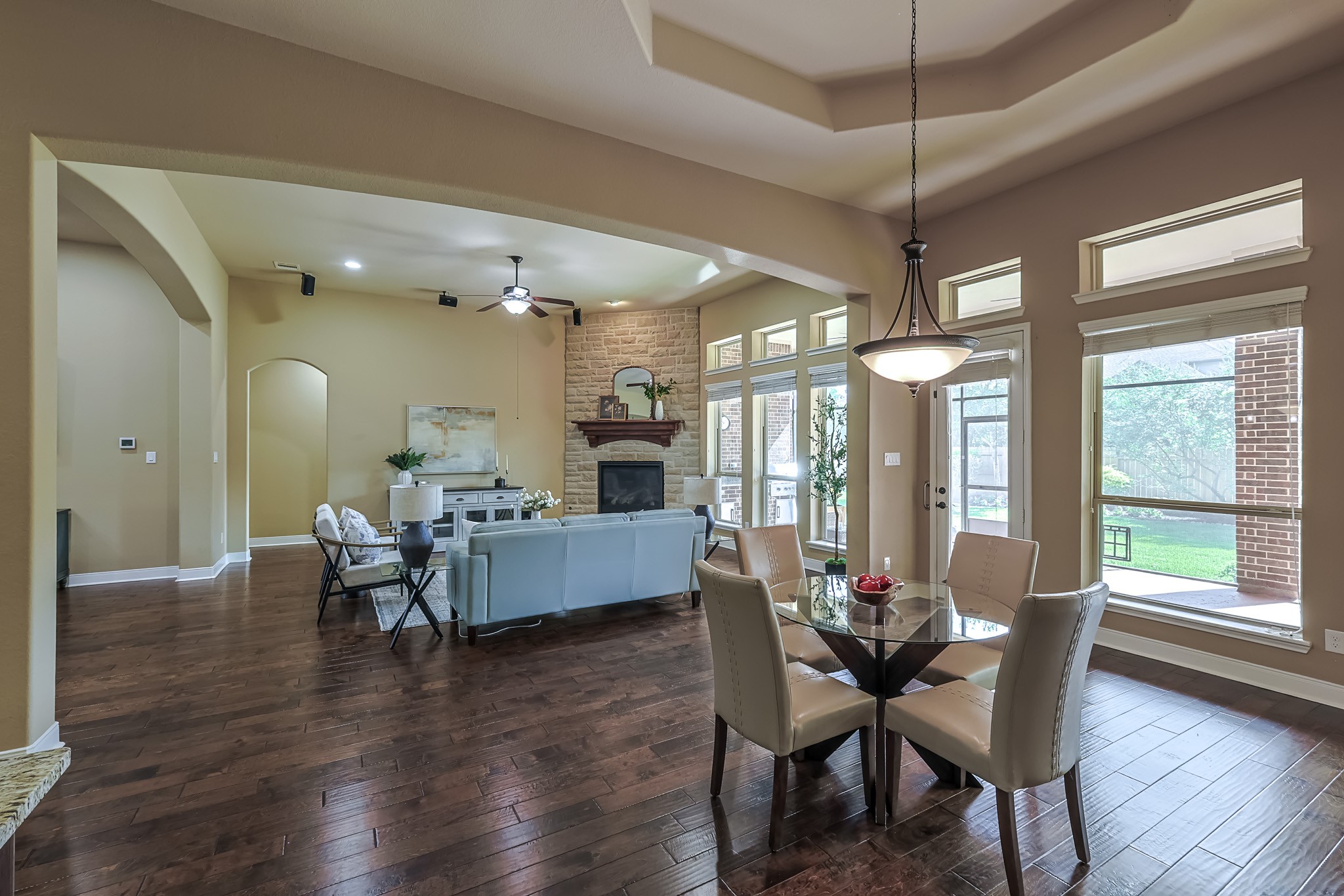 515 Mill Creek Road Pinehurst, TX 77362 - Photo 14 of 48 The dining space features a modern chandelier and overlooks a lush backyard.