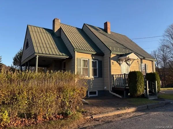a view of residential houses with outdoor space and trees