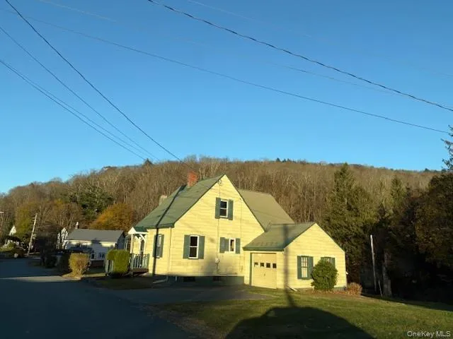a house with green field in front of it