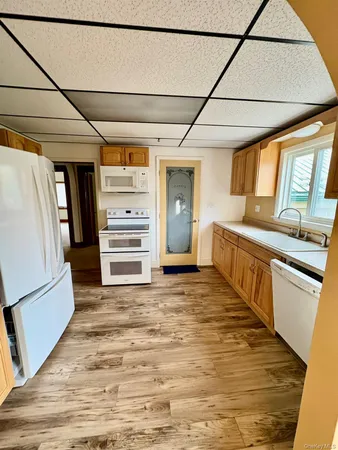 a room with a stove and a refrigerator