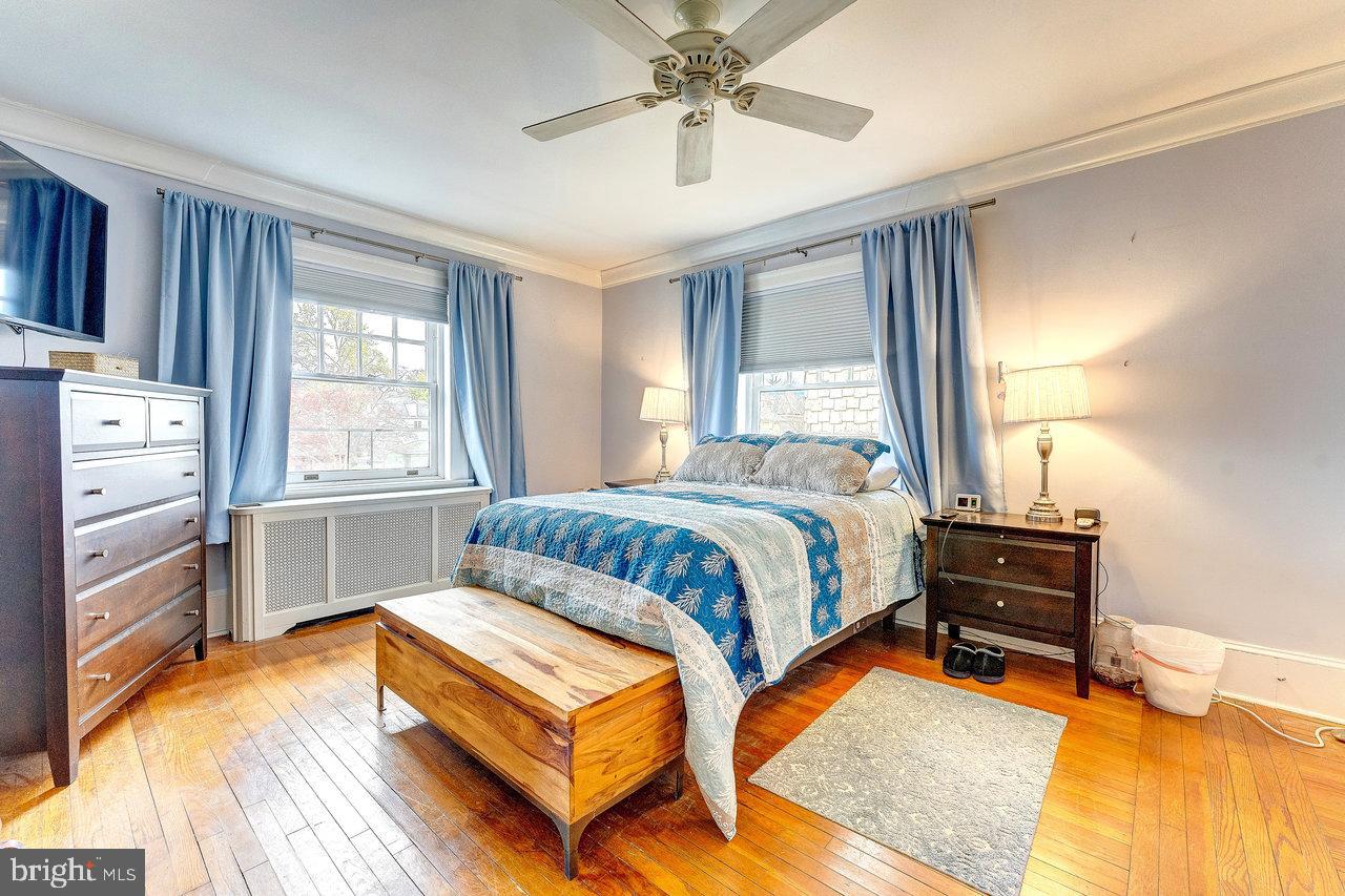 925 Berkeley Avenue Trenton, NJ 08618 - Photo 20 of 36 a bedroom with a bed and wooden floor