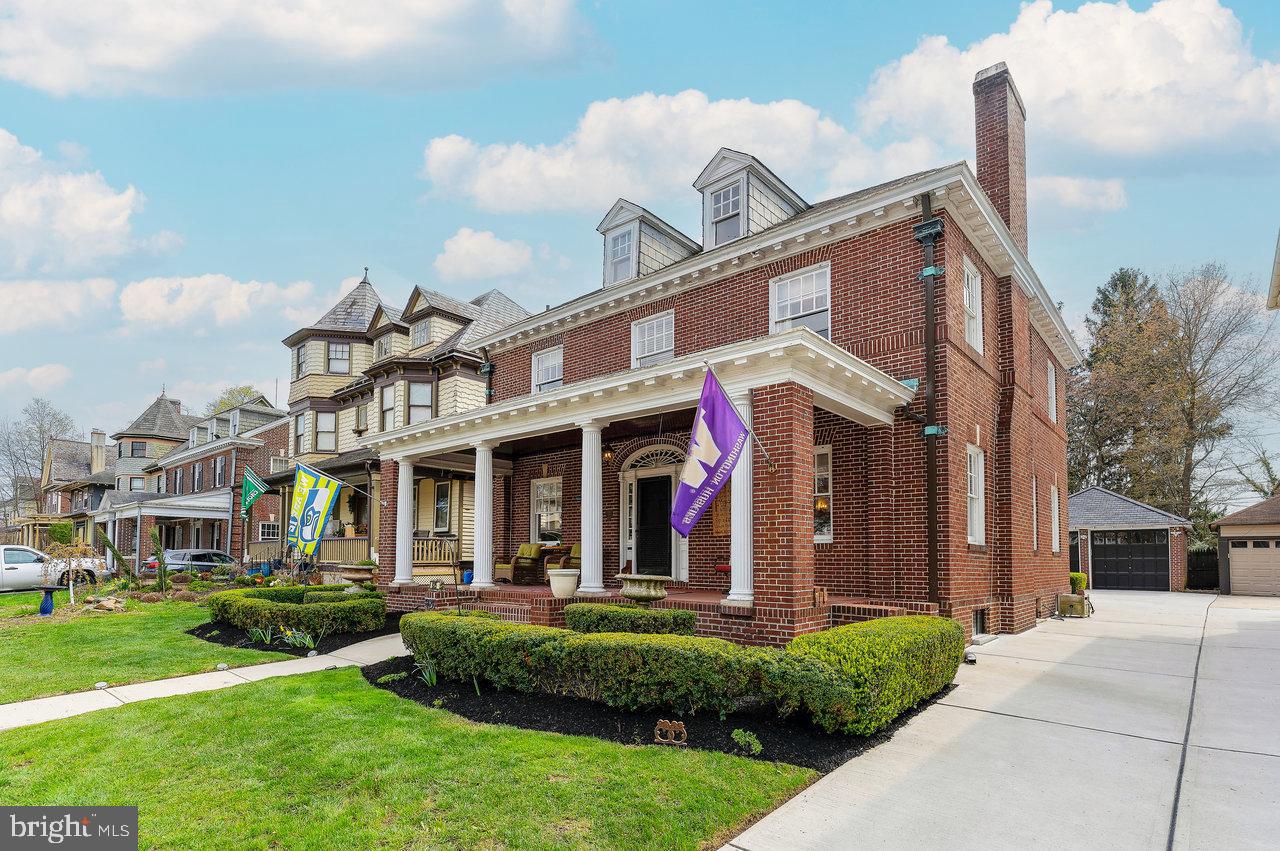 925 Berkeley Avenue Trenton, NJ 08618 - Photo 2 of 36 a view of a house with many windows and a yard
