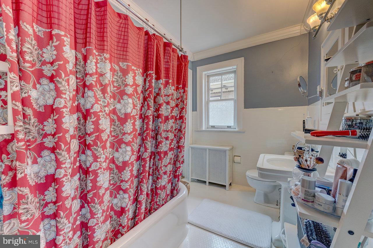 925 Berkeley Avenue Trenton, NJ 08618 - Photo 25 of 36 a bathroom with a sink toilet vanity and window