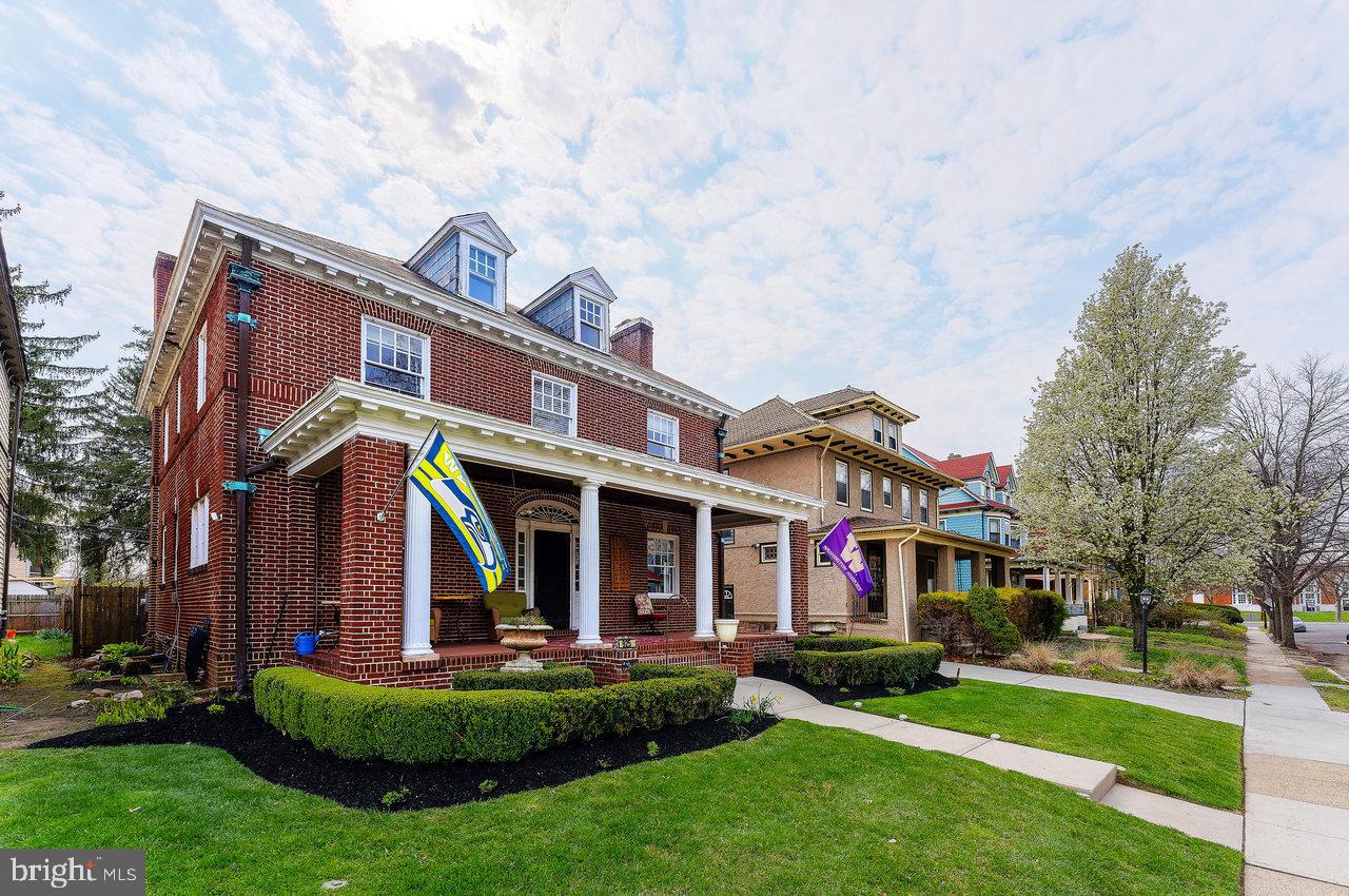 925 Berkeley Avenue Trenton, NJ 08618 - Photo 3 of 36 a view of a white house with a big yard and potted plants and large trees