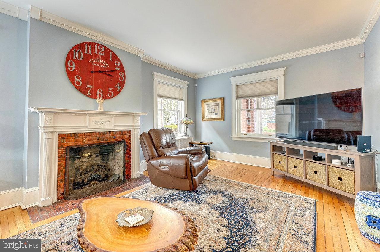 925 Berkeley Avenue Trenton, NJ 08618 - Photo 7 of 36 a living room with furniture and a fireplace